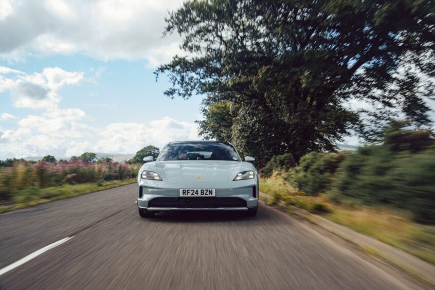 The Porsche seen from the front on a country road