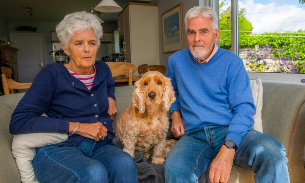 CR0049710 - Claire Warrender Story  - Fife Area  - Desmomd and Susan Montgomery's dog ''Razzi'' was attacked by two other dogs yesterday (Sunday 25/8/24) -  Picture shows Desmomd Montgomery, wife Susan Montgomery and their dog Razzi -- 1 Millfield, Cupar - Monday 26th August 2024  - Image: Steve MacDougall/DC Thomson