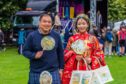 Left is kilted Councillor Andy Chan who helped to organise the event and Echo Zhu who's visiting from Qingdao, Kiautschou Bay in China. Image: Steve MacDougall/DC Thomson