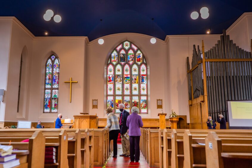 Kinnoull Parish church interior with parishioners taking seats in pews