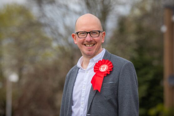 Brian Leishman wearing red Labour rosette