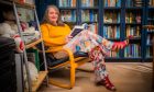 Sarah Clayton surrounded by books at her home in Perth. Image: Steve MacDougall/DC Thomson