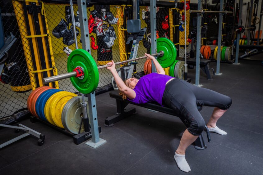 Lesley doing a bench press during the Sunday workout.