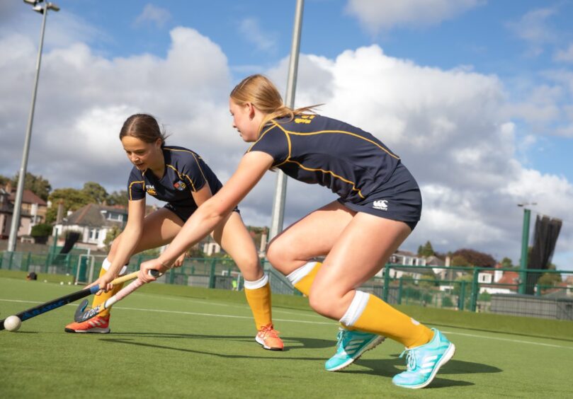 High School of Dundee pupils playing hockey.