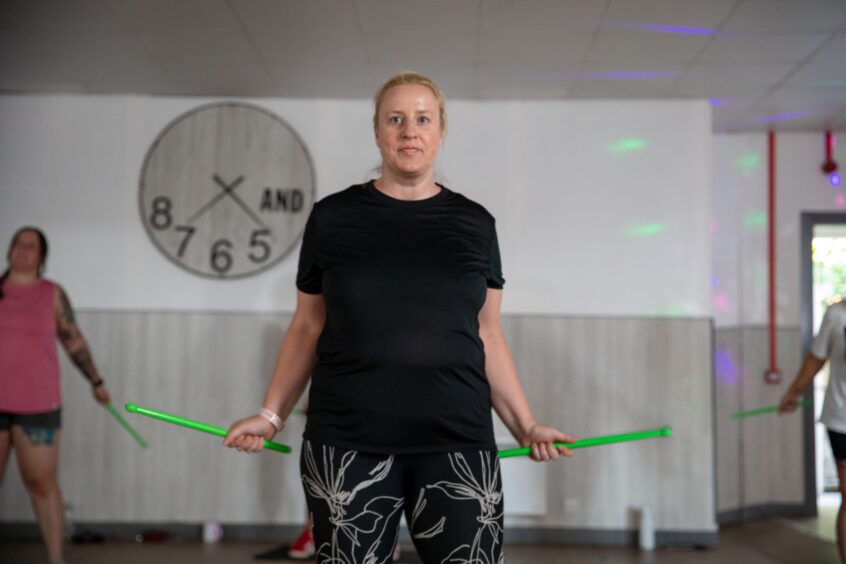 Debbie ready with her drumsticks for the Rockbox workout in Dundee.