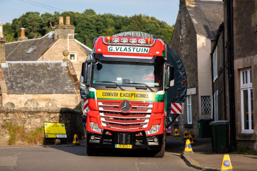 Lorry driving through narrow Dunning street with little room on either side