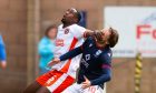 Emmanuel Adegboyega, left, scrapping for possession