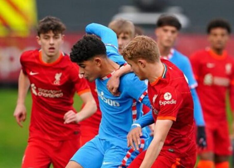 Luca Stephenson, foreground, and Owen Beck, far left, combine to close down Atletico Madrid's Salim El Jebari in the UEFA Youth League