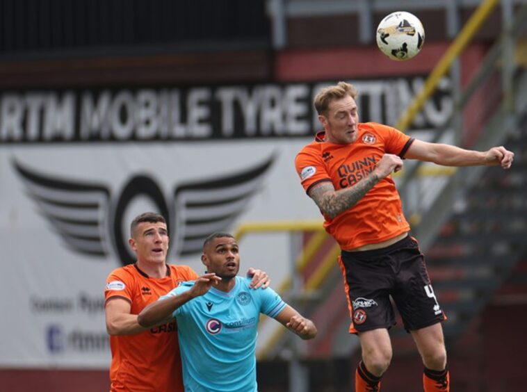 Kevin Holt, foreground, win one of myriad high balls for Dundee United