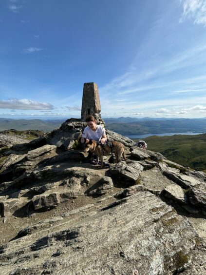 Katie Gardner and dog at top of Ben Lawers