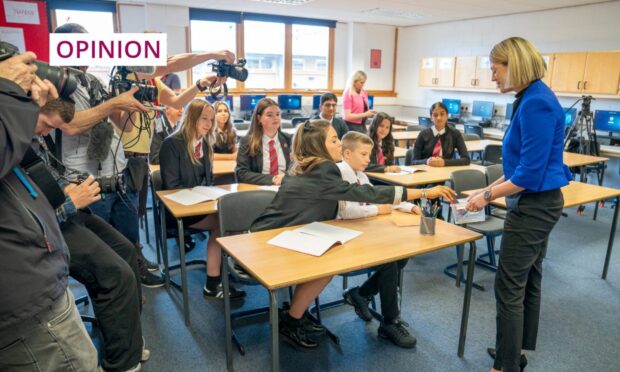 Education secretary Jenny Gilruth visiting a school to discuss banning phones. Image: PA