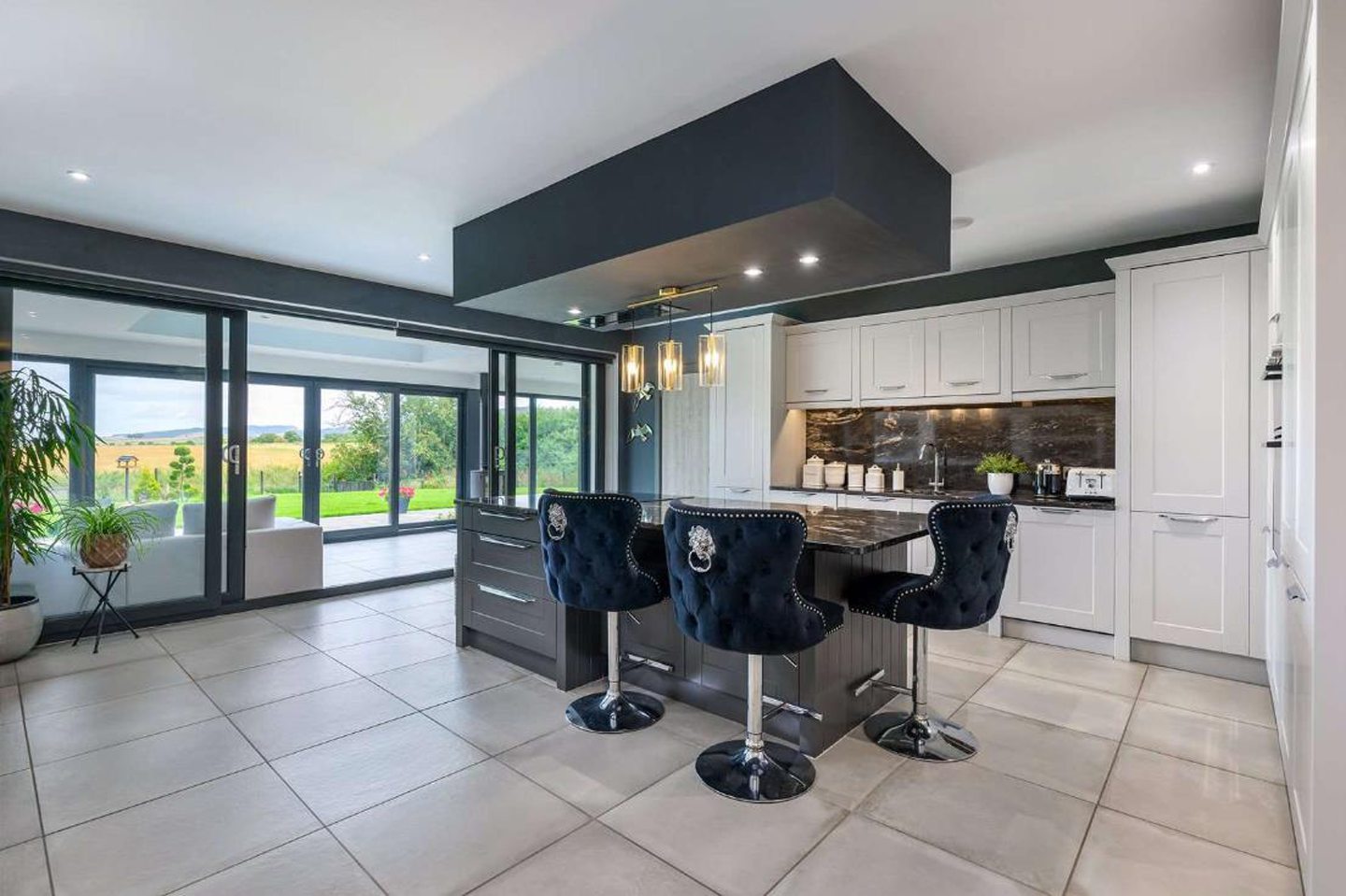 The kitchen, with the conservatory in the background.