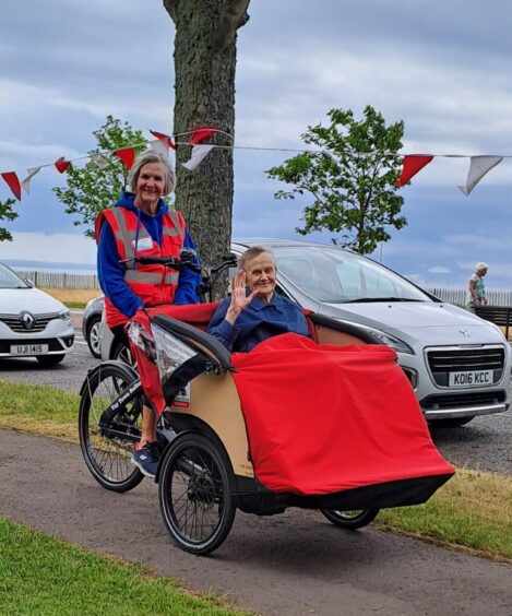 Trishaw captain Pauline Cameron with 98-year-old passenger Joyce.