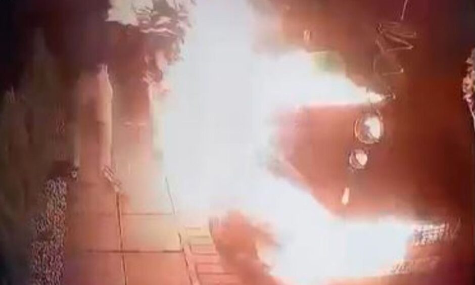 Security camera image of burning car