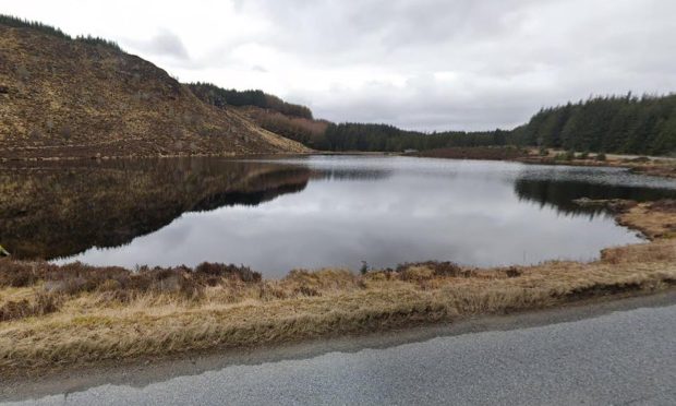 car lands in loch after crash