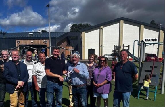 Council leader handing over keys for Letham Hub watched by invited guests