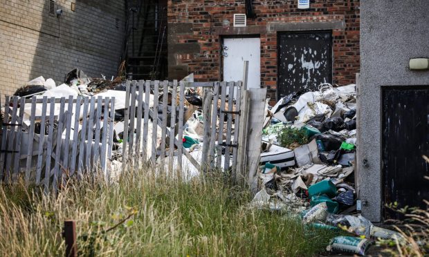 The pile of waste at the rear of the shops on Arbroath High Street. Image: Mhairi Edwards/DC Thomson