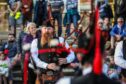 Crowds watching pipe band in centre of Crieff