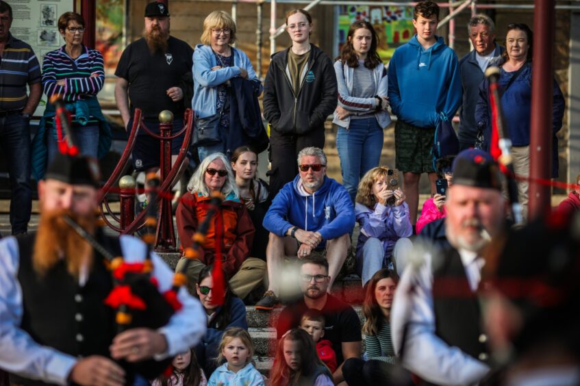 Crowd members watching pipe band performance in Crieff