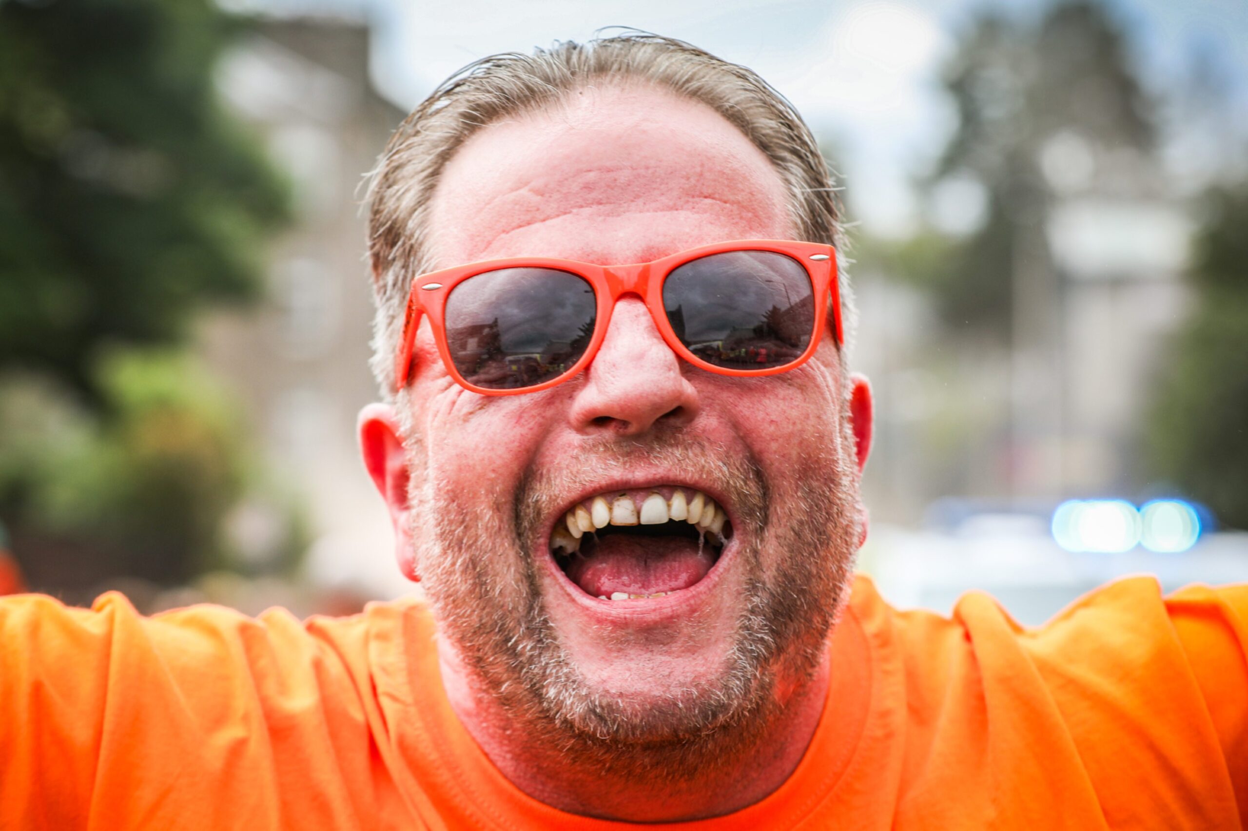 An excited Dundee United fans with orange sunglasses.