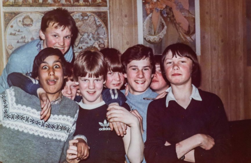 a group of boys smiling for the camera