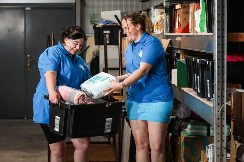 Charity manager Genna Millar with healthy eating coordinator Lauren Bell in the warehouse sorting a package. 