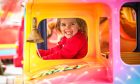 Lottie Clark, 2, has a great time on the rides at the Lammas Market in St Andrews