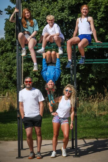 Emma and the family on a climbing frame