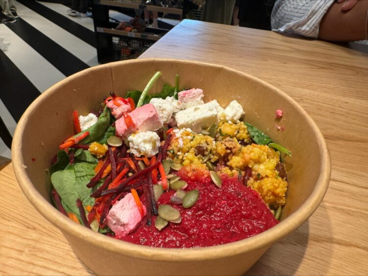 a bowl filled with the feta and fruity cous cous salad.