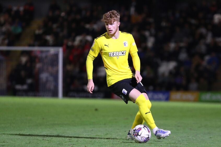 Luca Stephenson strides out of defence for Barrow against Grimsby