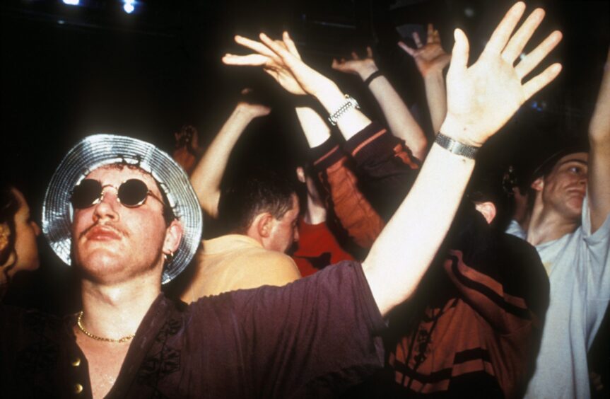 Clubbers with hands in air at Amnesia nightclub in 1991