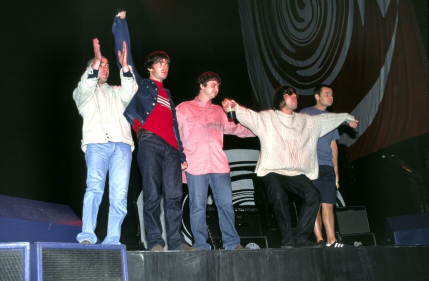 Oasis on stage at Knebworth in 1996.