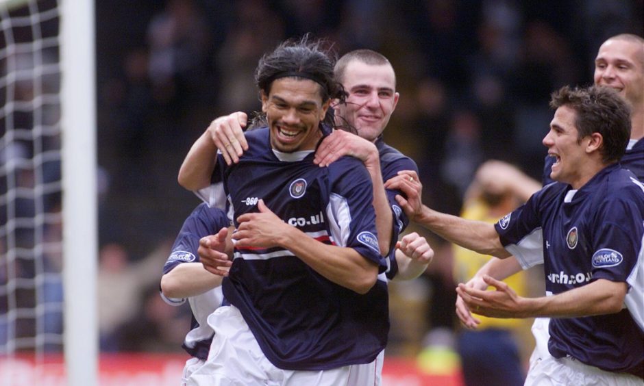 A smiling Fabian Caballero is mobbed by his Dundee FC team-mates as he celebrates his last-minute goal against Kilmarnock in October 2002.