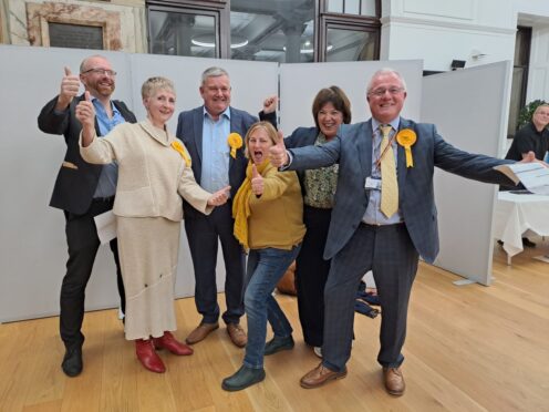 Alan Watt celebrating with group of supporters at Perth and Kinross election count