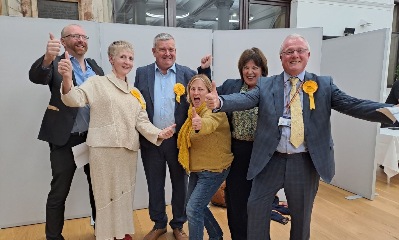 Alan Watt celebrating with group of supporters at Perth and Kinross election count