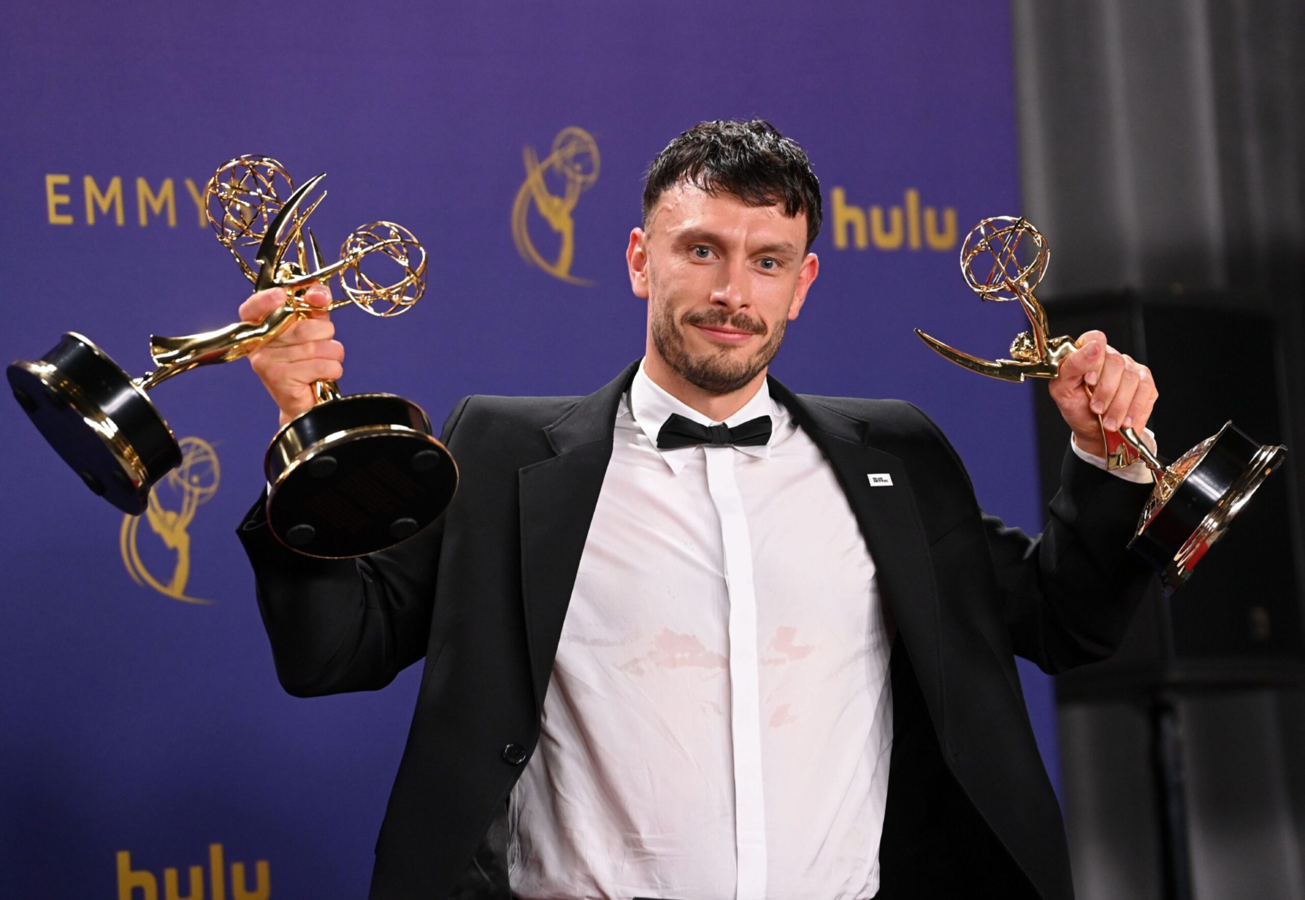 Richard Gadd holding three Emmys