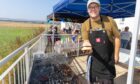 John Wilkin mans the BBQ at the Eassie Hall 100th birthday party. Image: Paul Reid