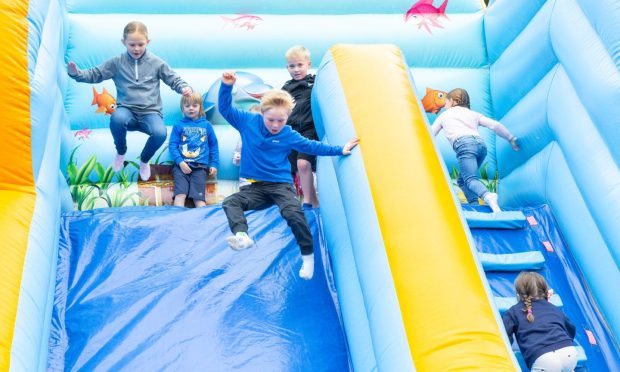 Jack Yule (right), 6, and Sophie Culross, 7, on the bouncy castle. Image: Paul Reid