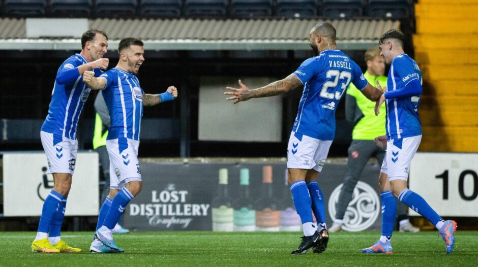 Kilmarnock players celebrate the only goal in a fixture notable for protests by the away fans