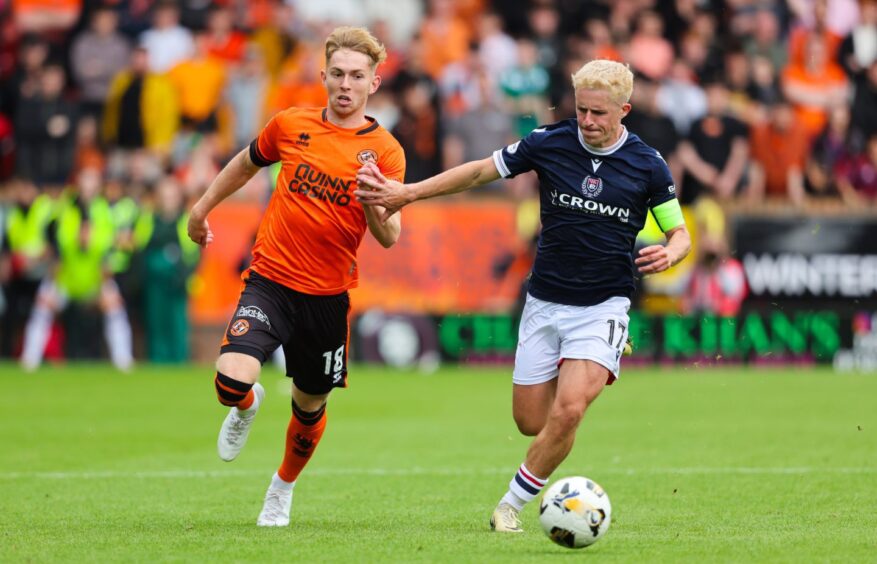 Kai Fotheringham races Luke McCowan in the Dundee derby - his most recent appearance for Dundee United