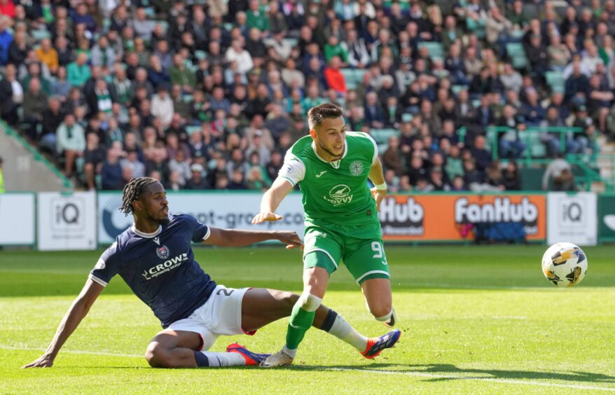 Billy Koumetio gets a foot in for Dundee at Hibs. Image: SNS