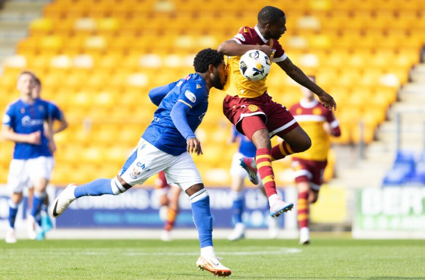 Andre Raymond in action against Motherwell, competing for an aerial ball