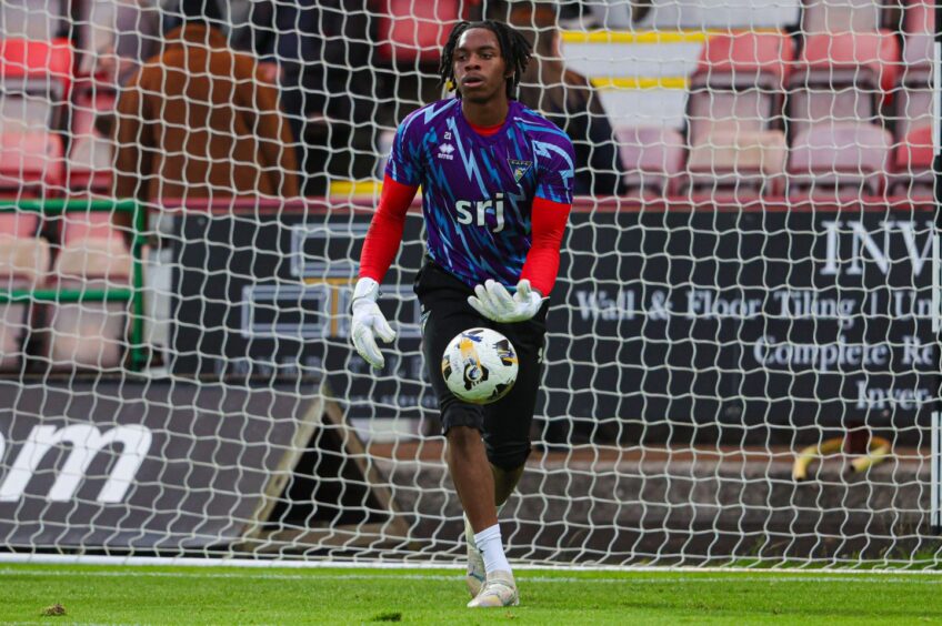 Tobi Oluwayemi warms up before a Dunfermline Athletic match.