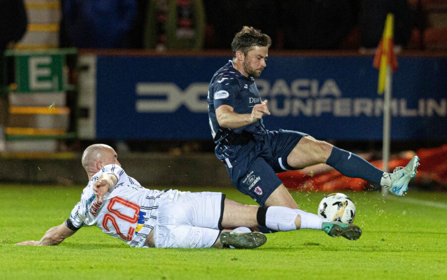 Dunfermline striker Chris Kane slides in to tackle Lewis Stevenson