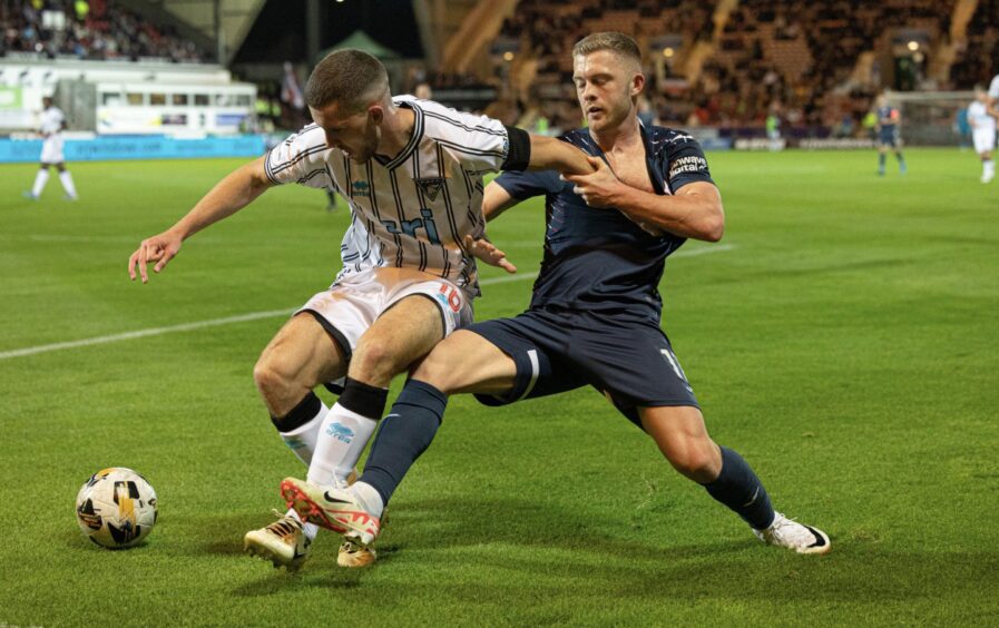 Tommy Fogarty holds off Raith Rovers striker Callum Smith in Dunfermline's Fife derby victory.