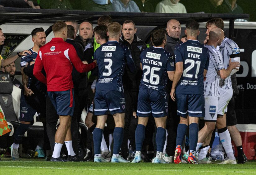 Players and staff from both teams get involved in a second-half melee.