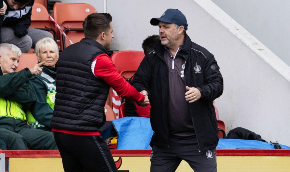 Falkirk assistant Paul Smith shakes hands with Airdrie manager Rhys McCabe.