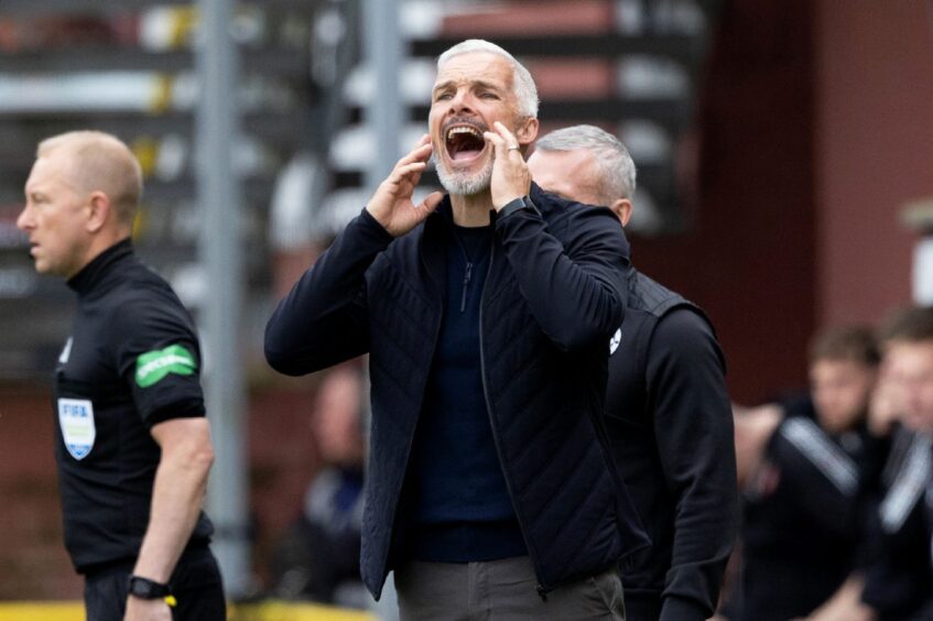 Dundee United boss Jim Goodwin encourages his side against Rangers.