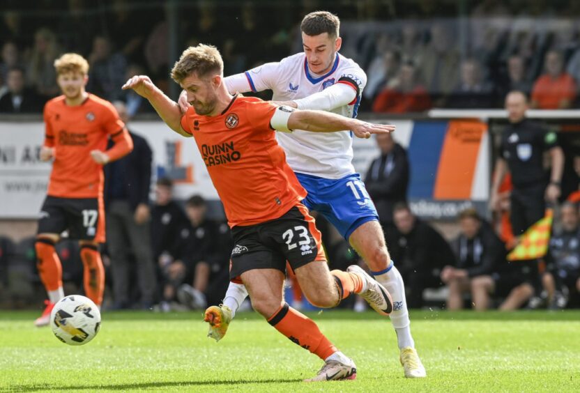 The excellent ROss Docherty spins away from match-winner Tom Lawrence for Dundee United