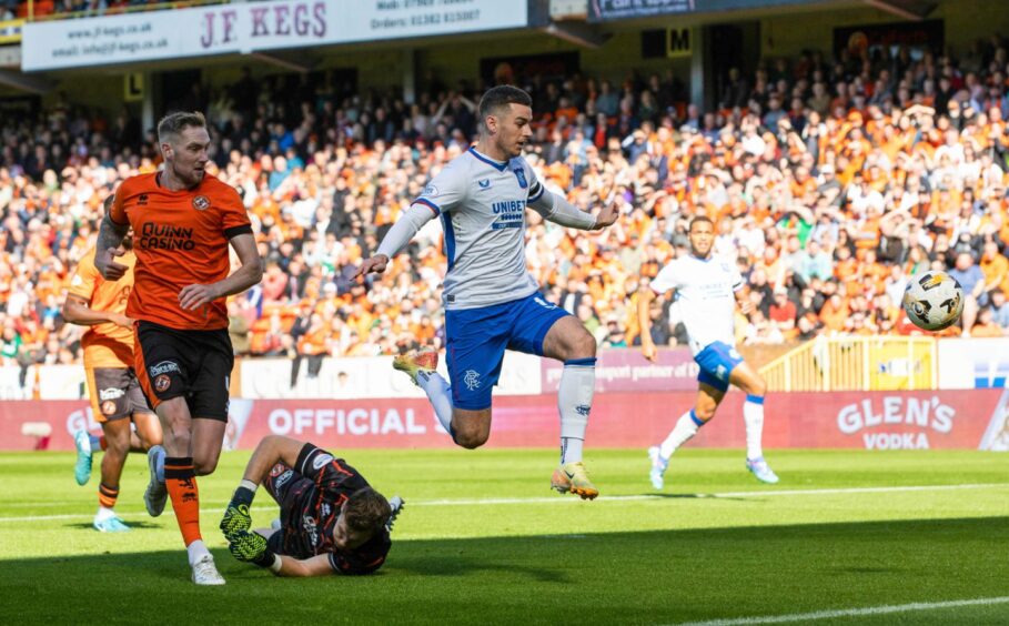 Tom Lawrence clips home the decisive goal for Rangers against Dundee United